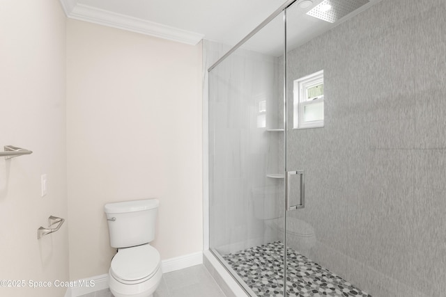 bathroom with tile patterned flooring, toilet, walk in shower, and ornamental molding