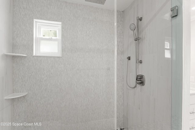 bathroom with tiled shower