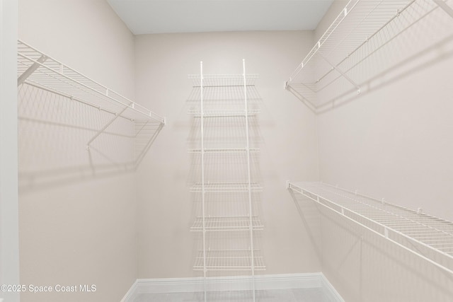 walk in closet featuring tile patterned flooring