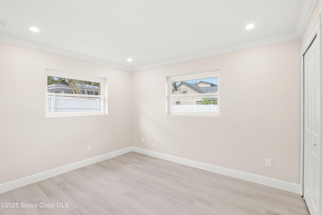 spare room with light hardwood / wood-style floors and ornamental molding