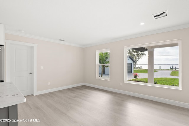 unfurnished room featuring light hardwood / wood-style flooring and ornamental molding