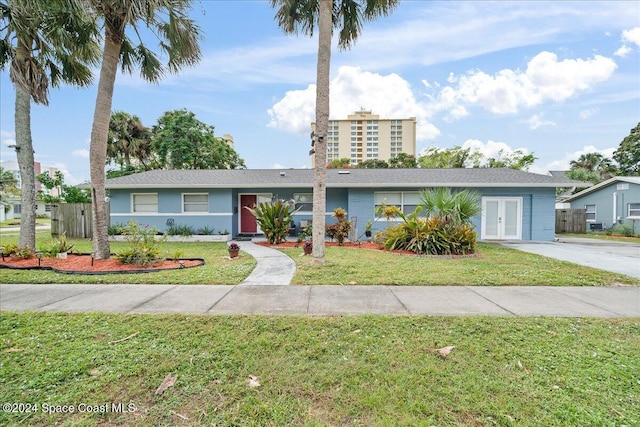 single story home with a front yard and french doors