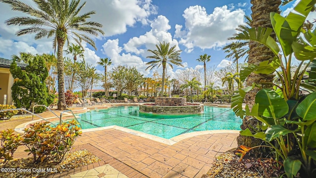 view of swimming pool with a jacuzzi