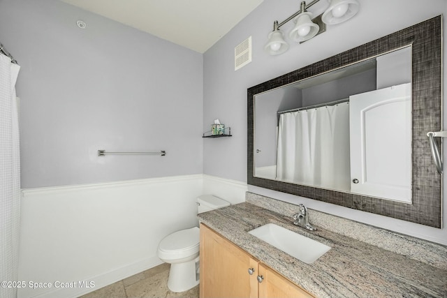 bathroom featuring tile patterned floors, vanity, and toilet