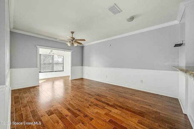 unfurnished room featuring dark hardwood / wood-style flooring, ceiling fan, and crown molding