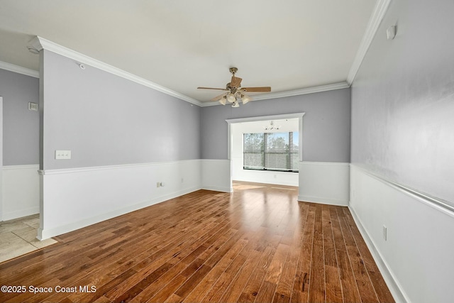 spare room featuring ceiling fan, crown molding, and hardwood / wood-style flooring