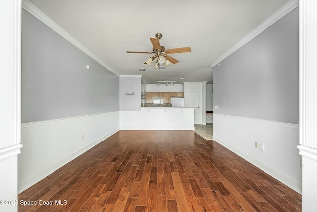 unfurnished living room featuring ceiling fan, crown molding, and dark wood-type flooring