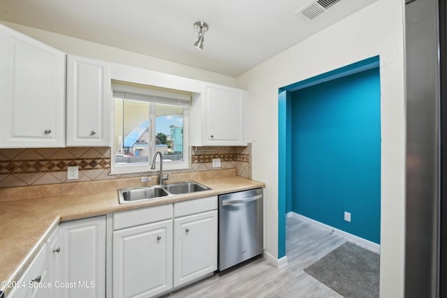 kitchen featuring stainless steel dishwasher, light wood-type flooring, white cabinetry, and sink