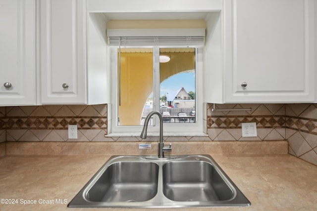 kitchen featuring white cabinets and sink