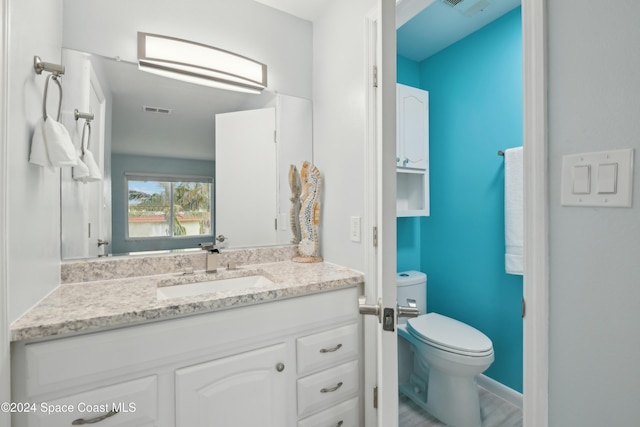 bathroom with vanity and toilet