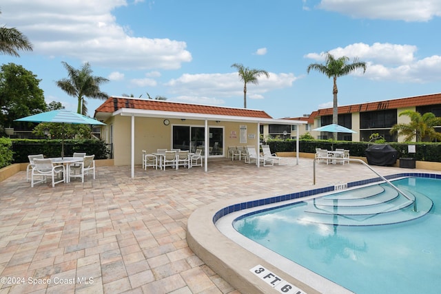 view of pool with a patio area and area for grilling