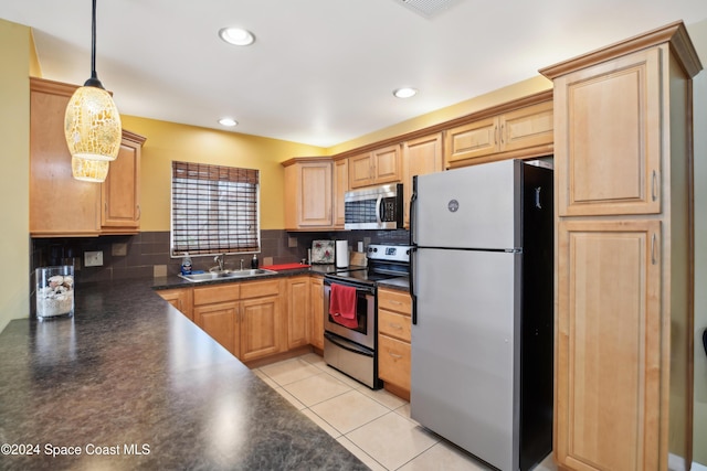 kitchen with pendant lighting, sink, decorative backsplash, appliances with stainless steel finishes, and light tile patterned flooring