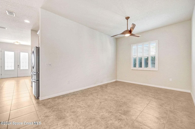 unfurnished room featuring light tile patterned floors, a textured ceiling, french doors, and ceiling fan