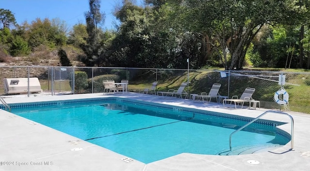 view of swimming pool featuring a patio area