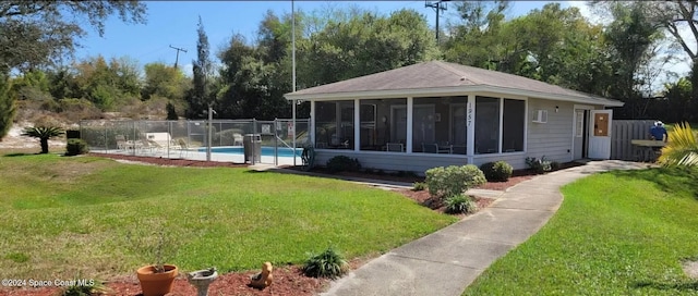 exterior space featuring a fenced in pool, fence, a yard, and a sunroom