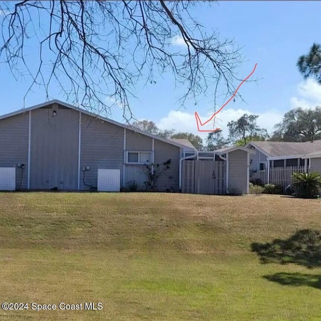 view of property exterior with a lawn