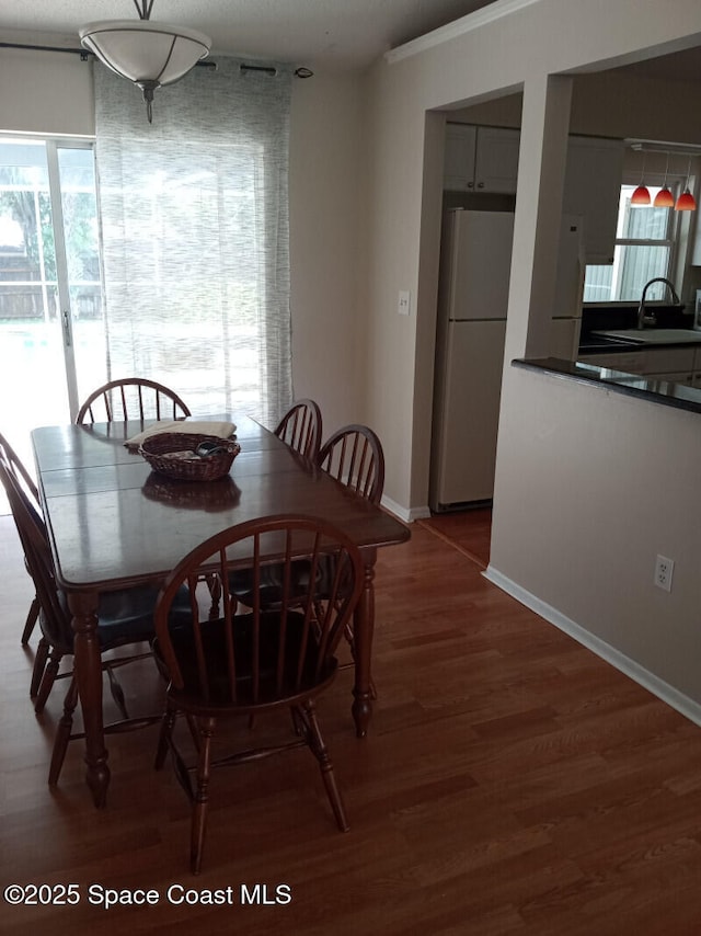 dining area with hardwood / wood-style flooring and sink