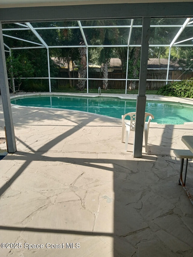 view of pool with a lanai and a patio