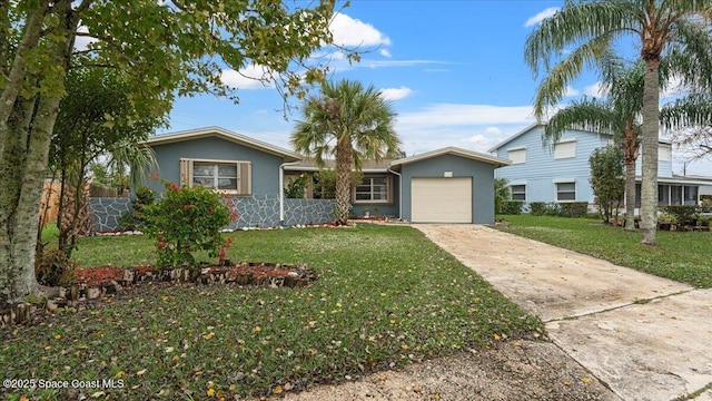 view of front of house with a front yard and a garage