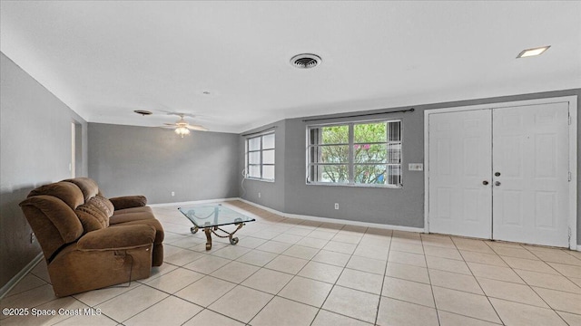 tiled living room featuring ceiling fan