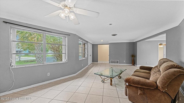 tiled living room with ceiling fan