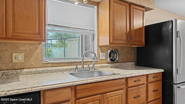 kitchen with tasteful backsplash, stainless steel fridge, sink, and dishwasher