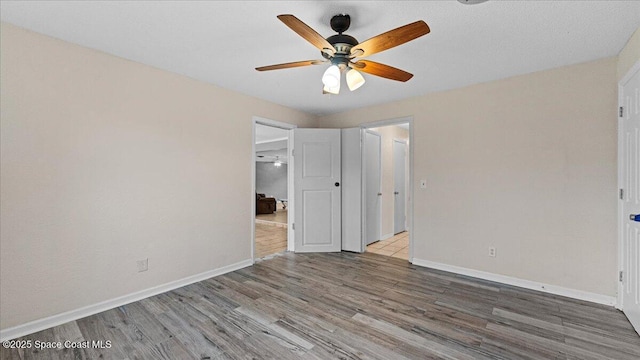 unfurnished bedroom featuring ceiling fan and wood-type flooring