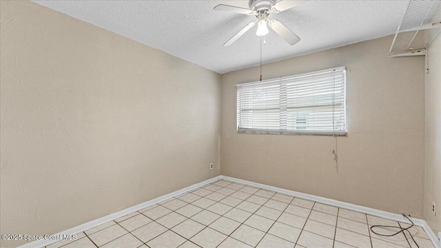 empty room with ceiling fan and a textured ceiling