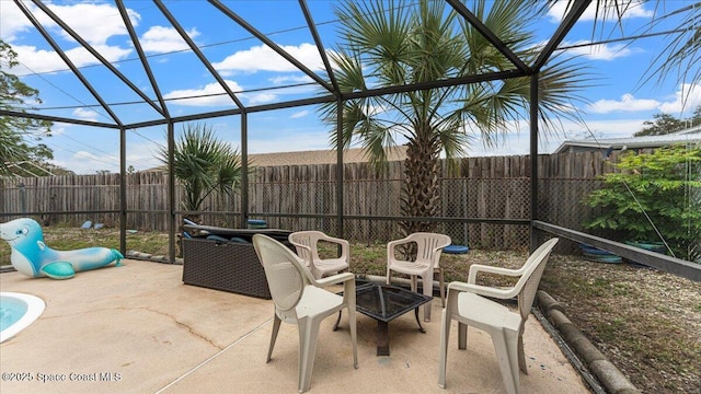 view of patio with glass enclosure