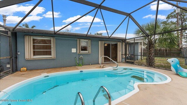 view of pool with a lanai and a patio