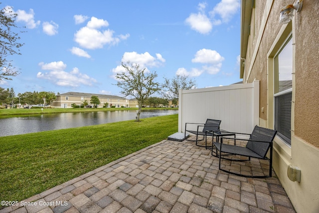 view of patio with a water view