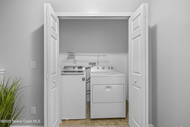 clothes washing area with independent washer and dryer