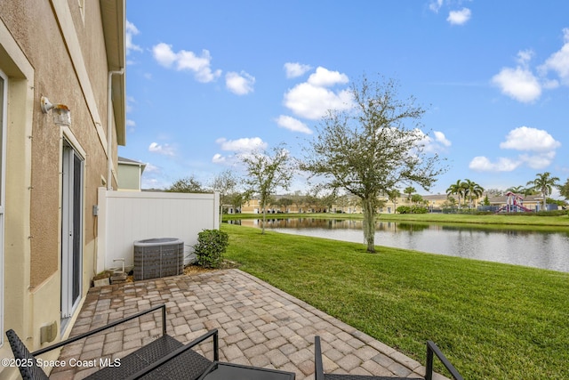 view of patio featuring central AC and a water view