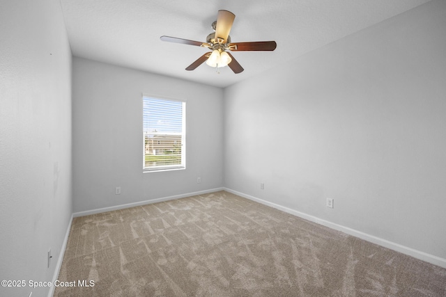 carpeted spare room featuring ceiling fan