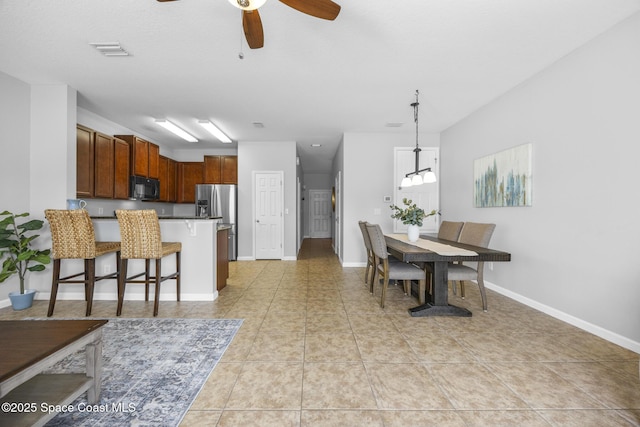 tiled dining area featuring ceiling fan