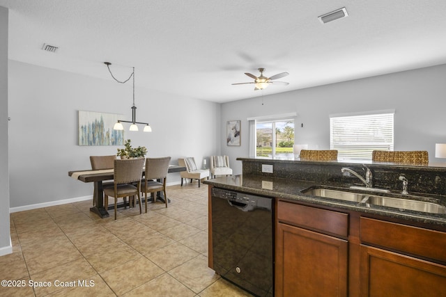 kitchen with dishwasher, dark stone counters, sink, ceiling fan, and decorative light fixtures