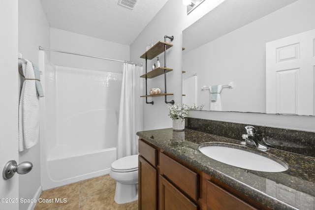 full bathroom featuring vanity, tile patterned floors, toilet, a textured ceiling, and shower / tub combo