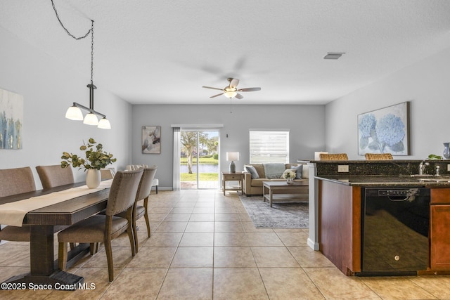 dining room with ceiling fan, light tile patterned flooring, and a textured ceiling