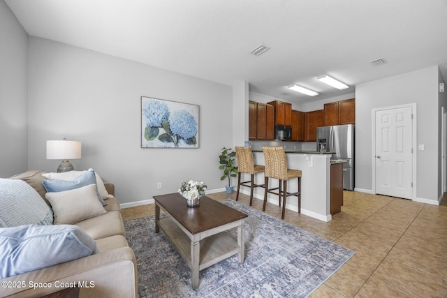 living room with light tile patterned floors