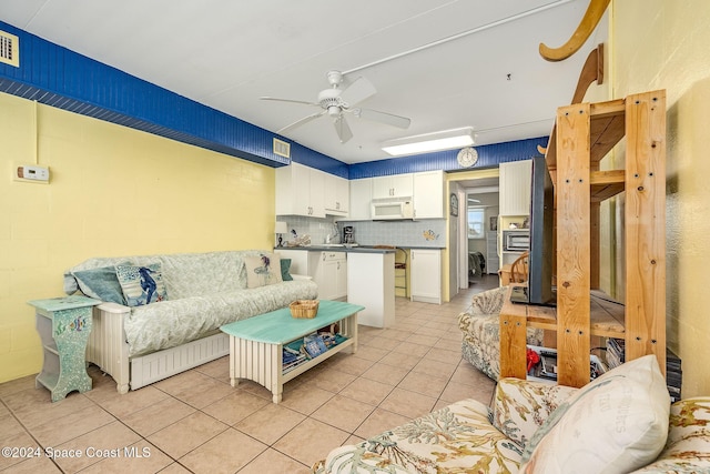 living room featuring ceiling fan and light tile patterned flooring