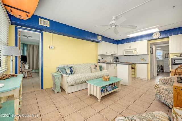 living room with ceiling fan and light tile patterned flooring