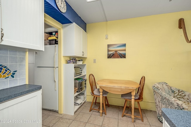 dining space featuring light tile patterned flooring