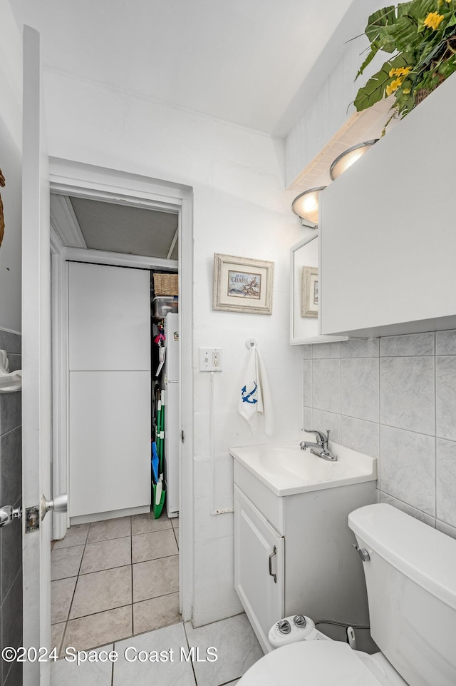 bathroom with tile patterned flooring, vanity, and toilet