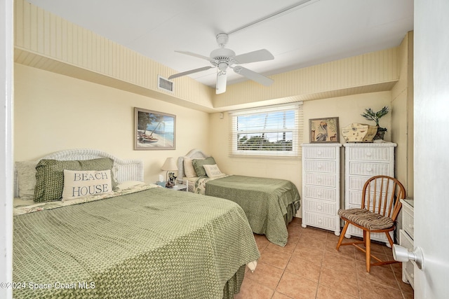 bedroom with ceiling fan and light tile patterned floors