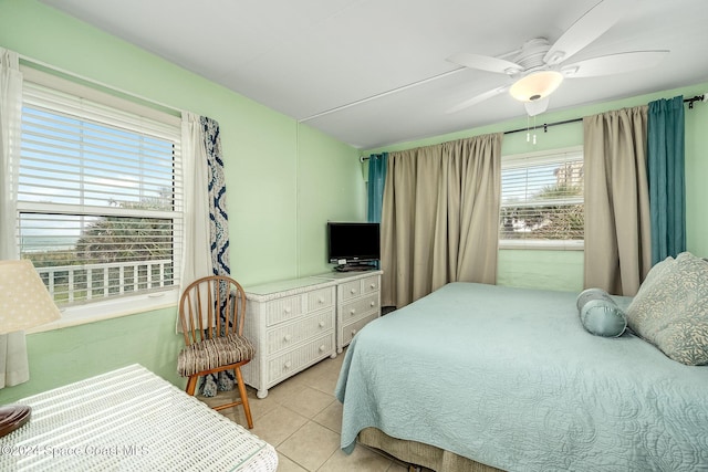 tiled bedroom featuring ceiling fan