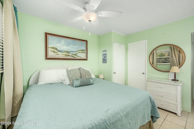 tiled bedroom with ceiling fan