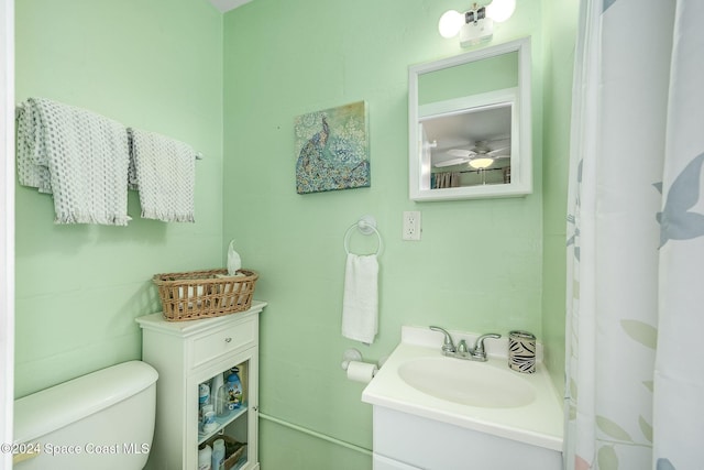 bathroom featuring ceiling fan, vanity, and toilet