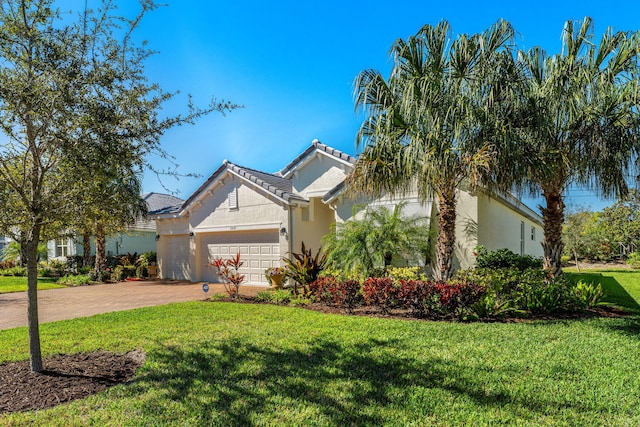 view of front of house with a front yard and a garage