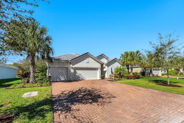 ranch-style home with a garage and a front lawn