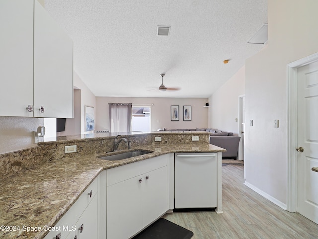 kitchen featuring sink, white cabinets, and stone countertops